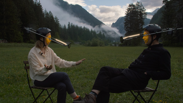 Film creators Luna Maurer and Roel Wouters on chairs in Swiss mountains