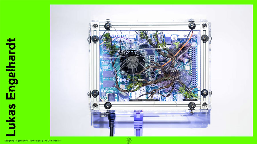 A small server that is transparent so that you can see purple and blue cables. The image is on a green surface